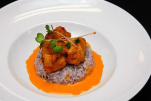 Buttermild Fried AShley Farms Chicken, Blue Corn Grits, Red Pepper Pernod Cream, Micro Red Radish